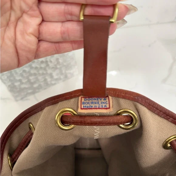 Dooney & Bourke Ivory and Brown Bucket Bag with Dachshund Leather Charm